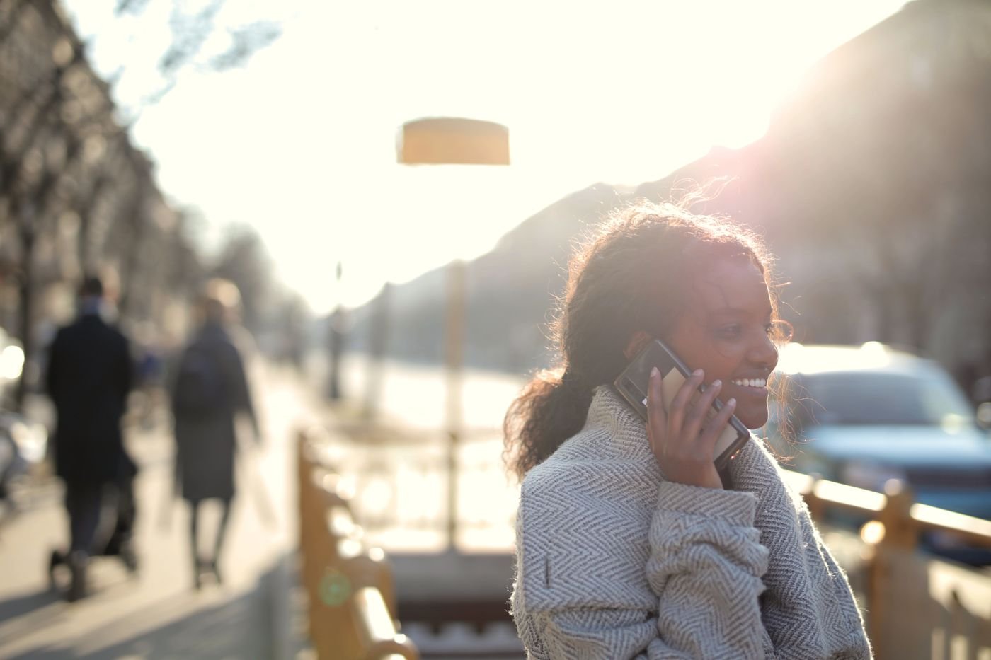 Smiling woman on a phone call booking a dental appointment