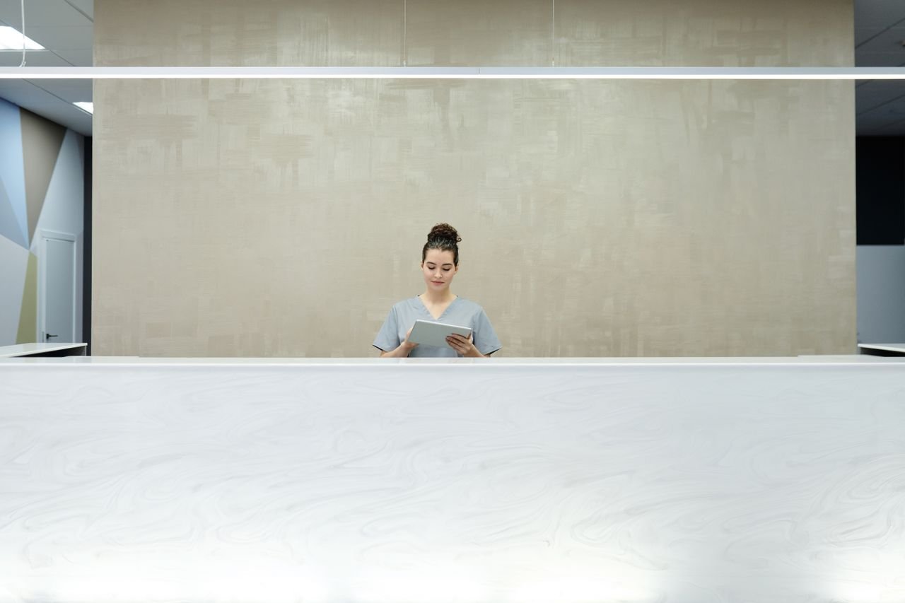 Receptionist checking a schedule on a tablet