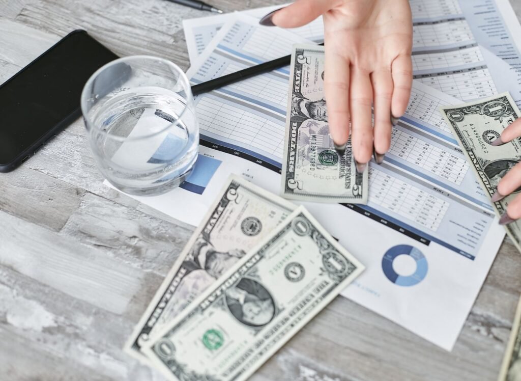 Financial documents and a calculator for planning a dental marketing budget