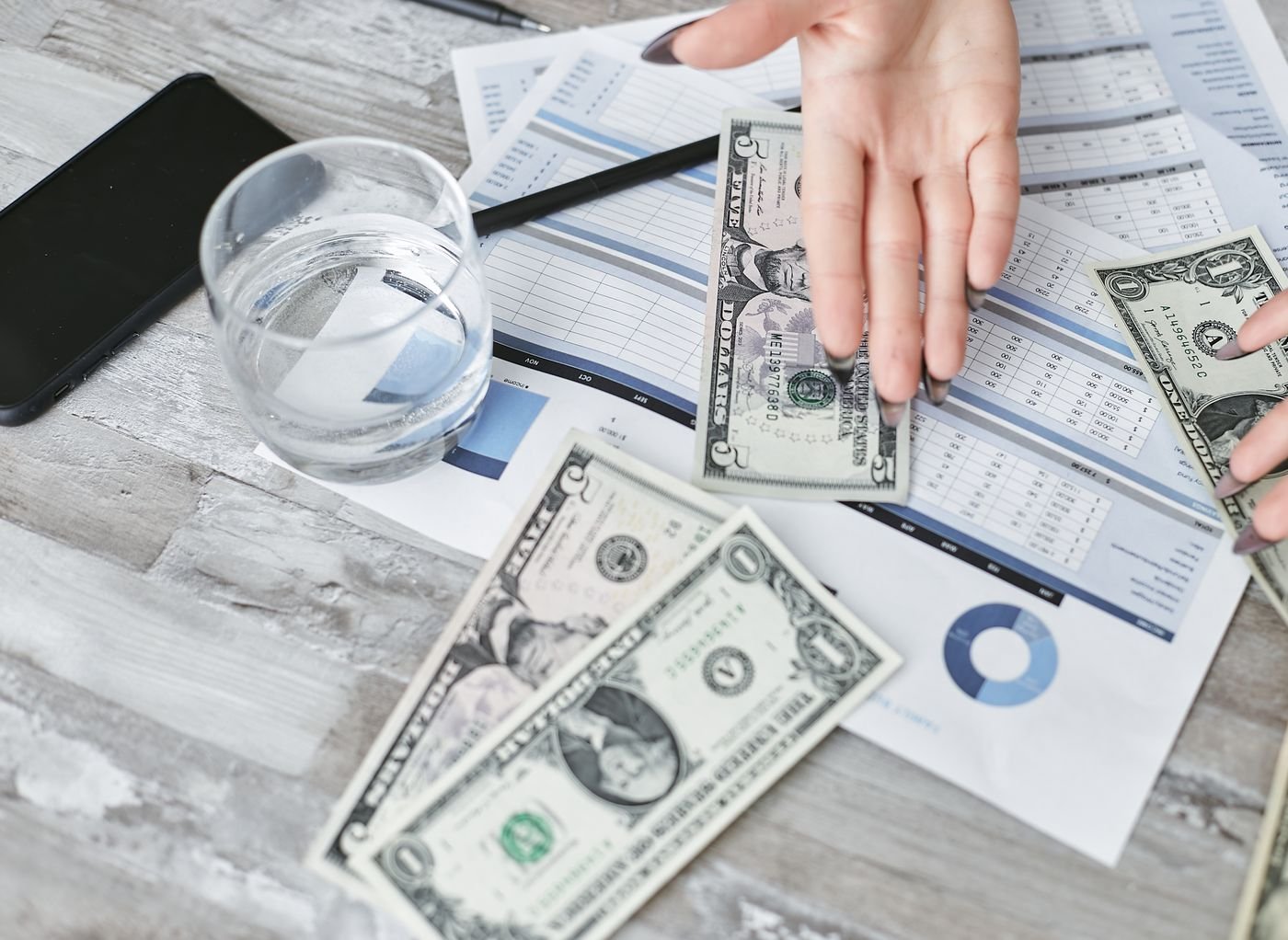 Financial documents and a calculator for planning a dental marketing budget