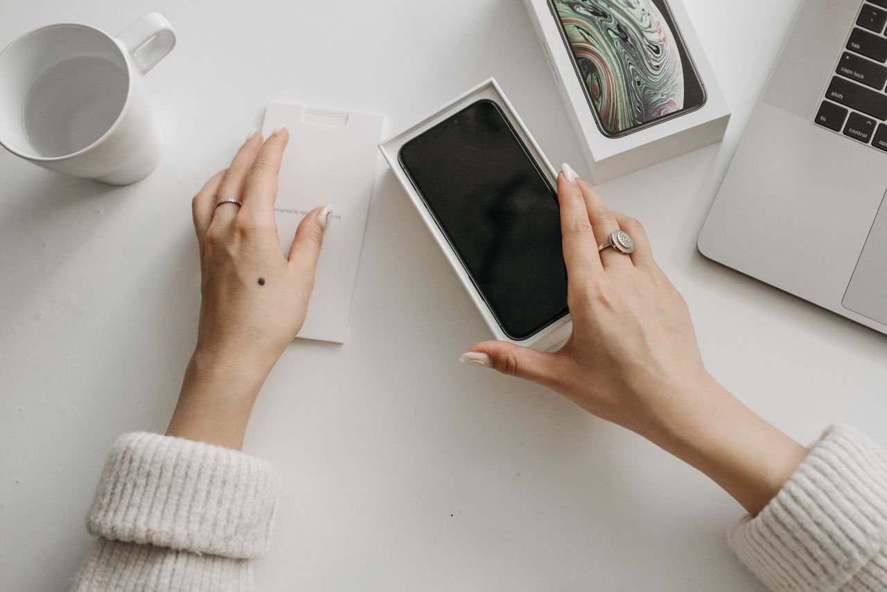 Person holding a smartphone reading online reviews of a dental practice