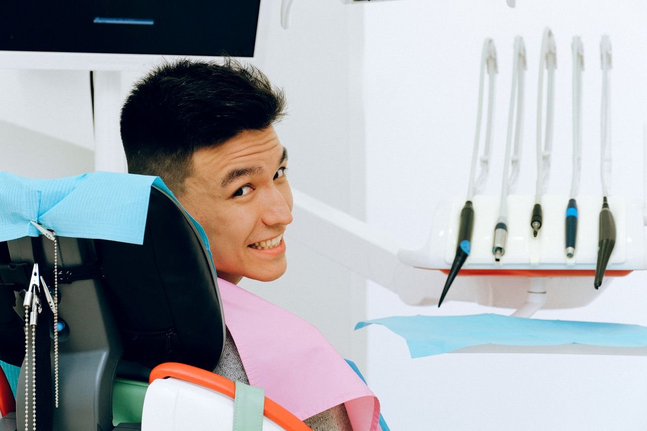 Smiling patient sitting in a modern independent dental office