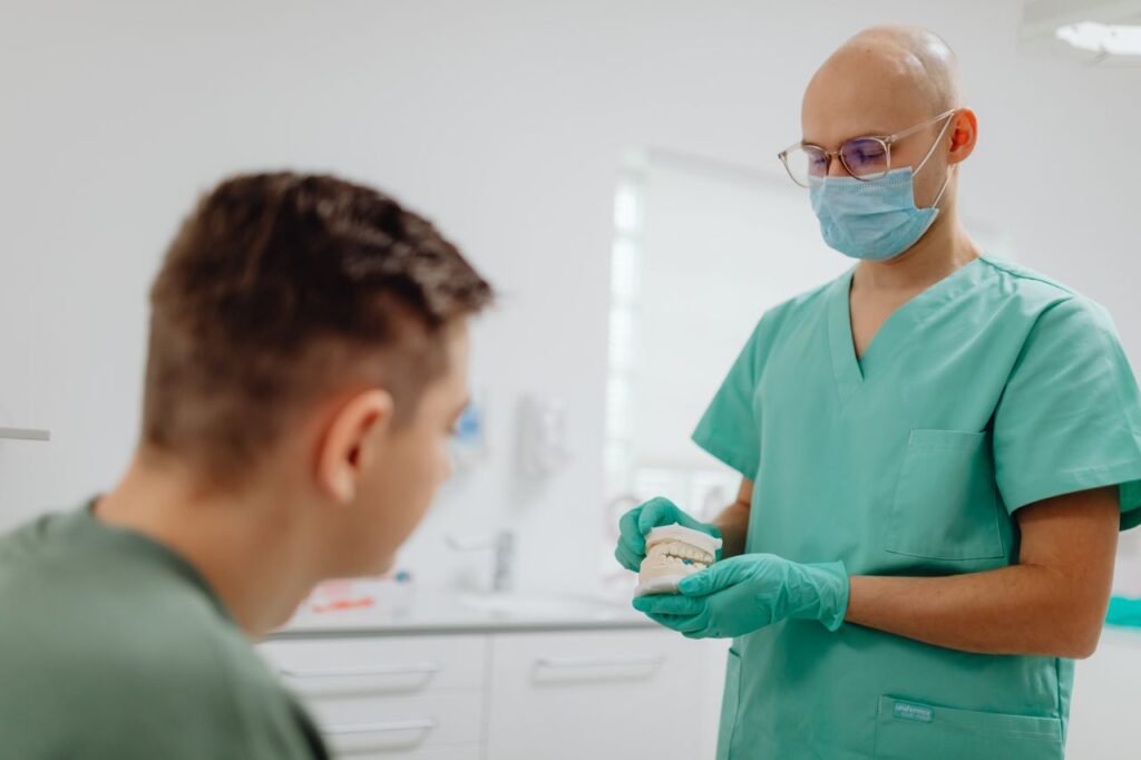Dentist having a treatment discussion with a patient in the dental chair
